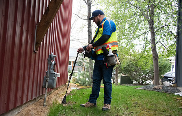 A gas meter is inspected for leaks.